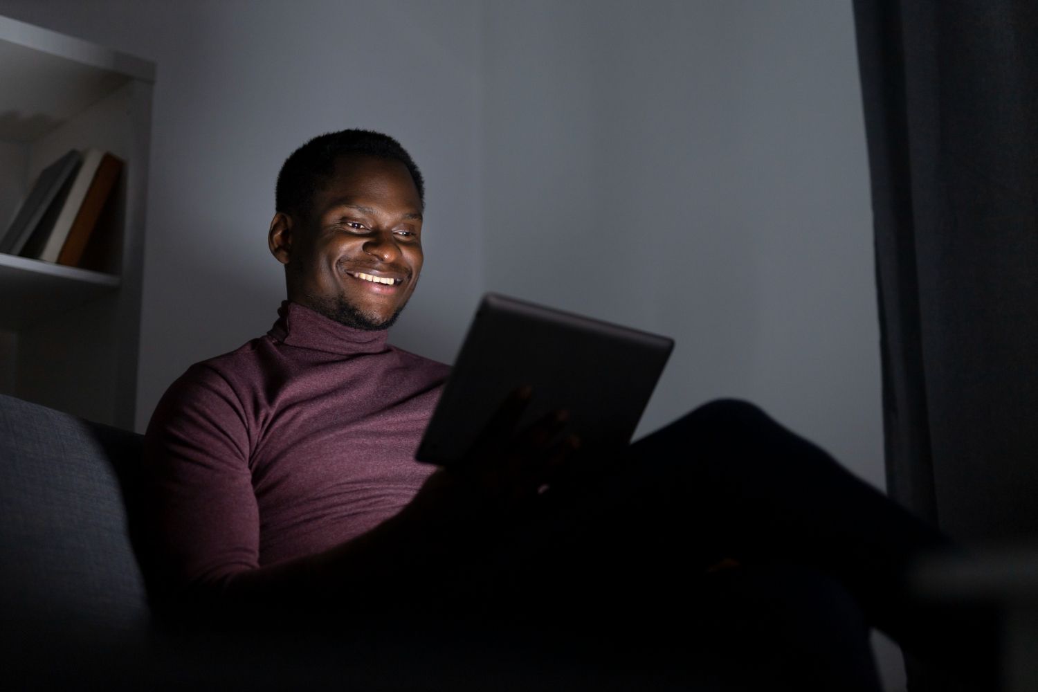 african american man watching streaming service home alone.jpg